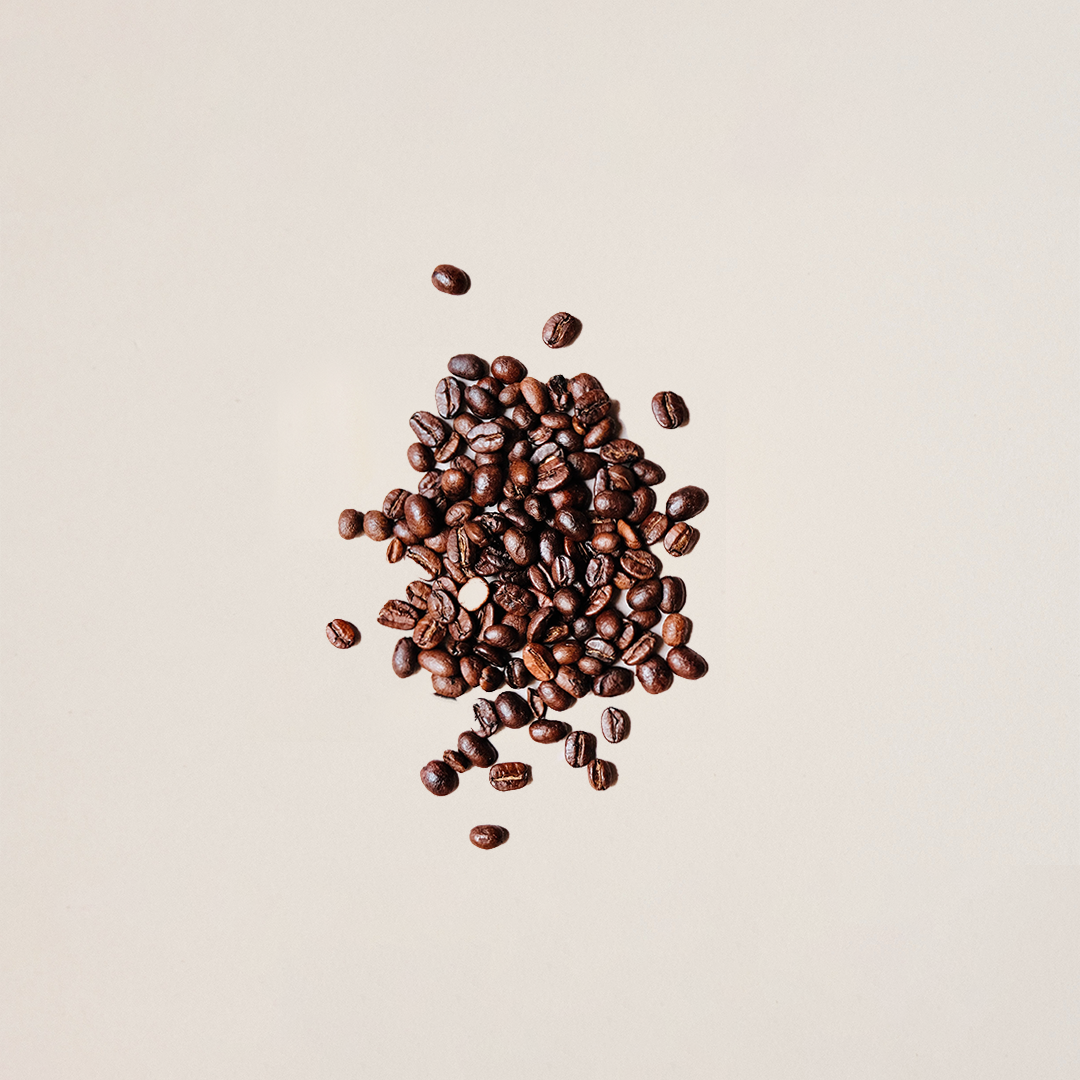 There are so many small coffee beans gathered together. It is in the center of the frame